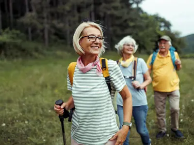 Mature woman enjoying her day in forest with friends 